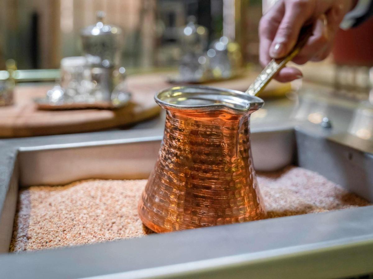 Mercure Trabzon Hotel Bagian luar foto Turkish coffee being prepared in a cezve